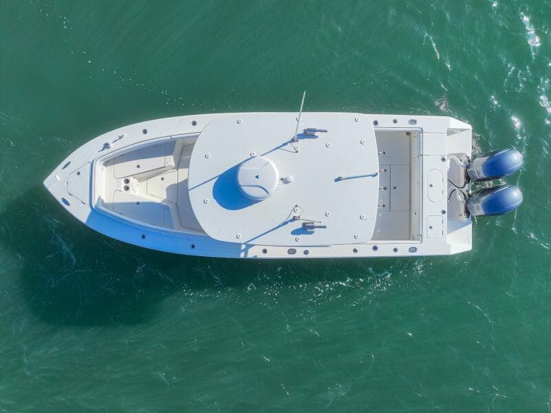 Aerial view of 2018 Jupiter 26 FS boat on turquoise water.