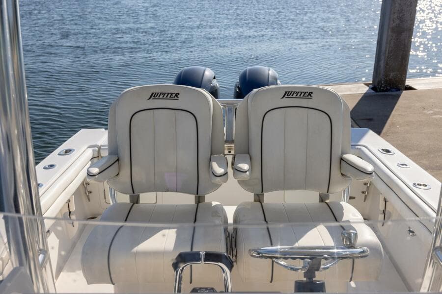 2018 Jupiter 26 FS boat with dual seats, docked by the water.