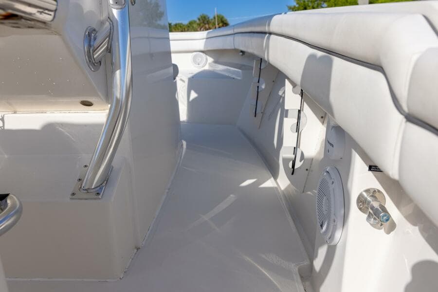 Interior view of a 2018 Jupiter 26 FS boat, featuring sleek white seating and stainless steel fixtures.