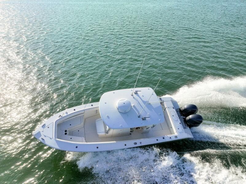 Aerial view of 2018 Jupiter 26 FS boat cruising on open water.