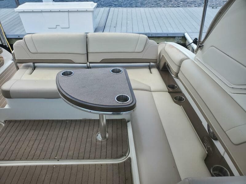 2015 Formula 330 Crossover Bowrider interior with cushioned seating and table.