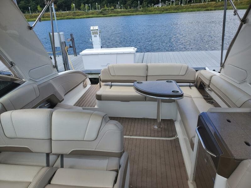 2015 Formula 330 Crossover Bowrider interior with seating and table by the water.