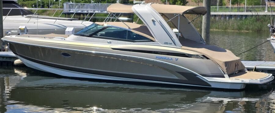 2015 Formula 330 Crossover Bowrider boat docked in a marina.
