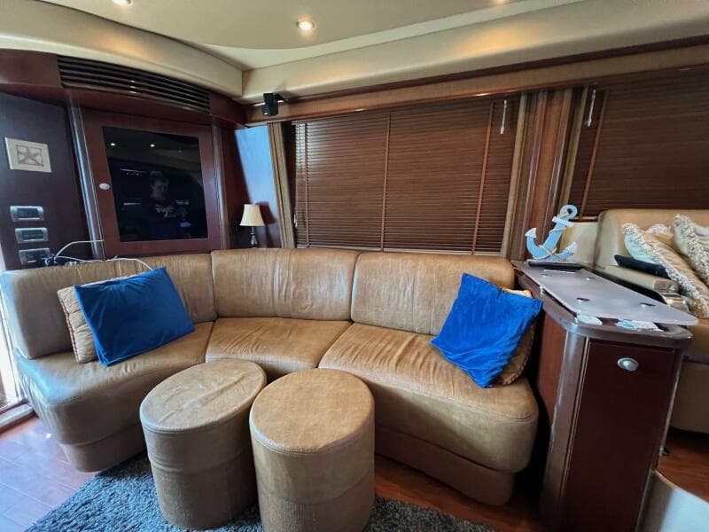 Luxurious interior of 2005 Sea Ray 500 Sedan Bridge with leather seating and nautical decor.