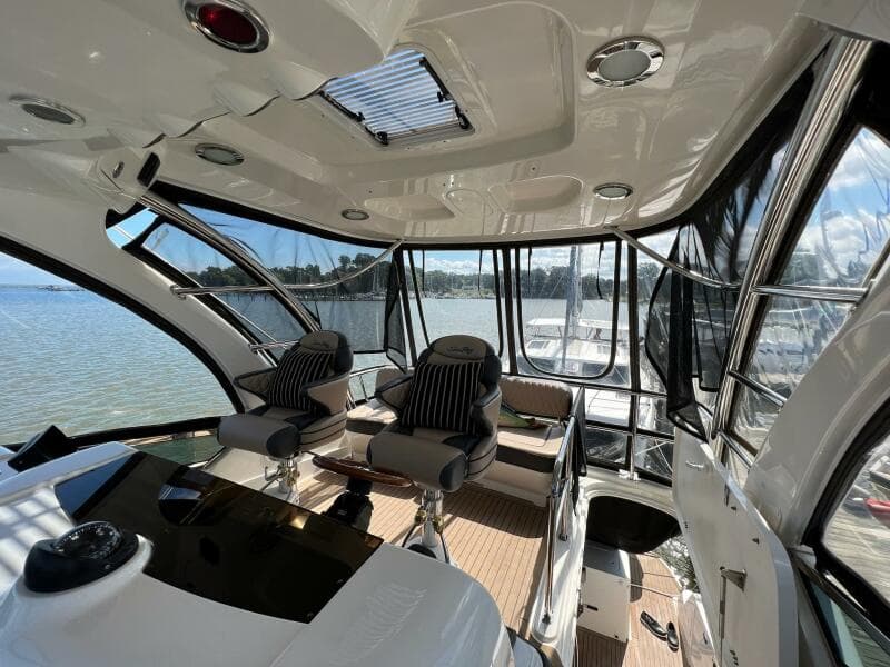 Interior of 2005 Sea Ray 500 Sedan Bridge yacht with panoramic windows and luxurious seating.