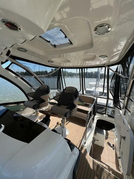 2005 Sea Ray 500 Sedan Bridge interior with seating, panoramic windows, and sleek design.