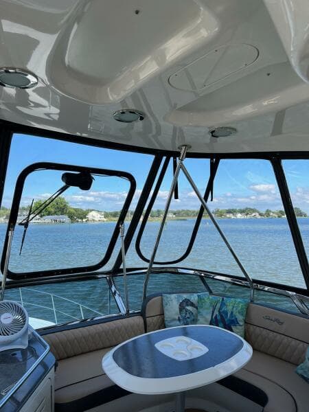 Interior view of 2005 Sea Ray 500 Sedan Bridge yacht with scenic water backdrop.