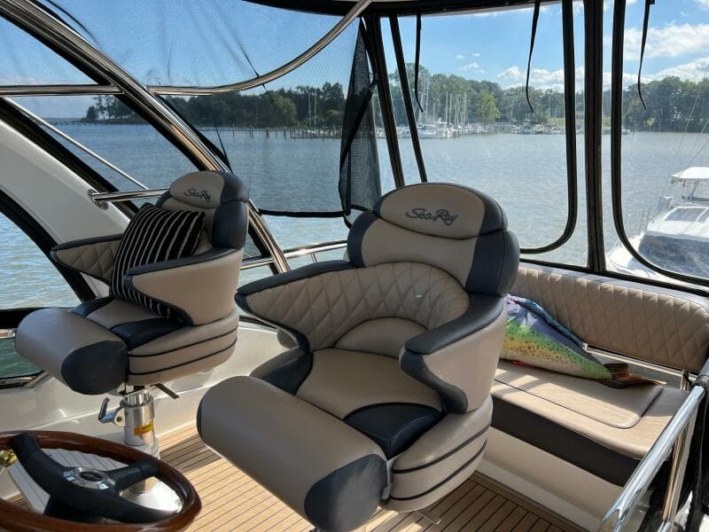 Luxurious 2005 Sea Ray 500 Sedan Bridge interior with plush seating and scenic water view.