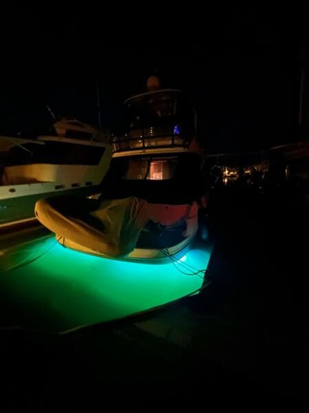 2005 Sea Ray 500 Sedan Bridge with glowing underwater lights at night.