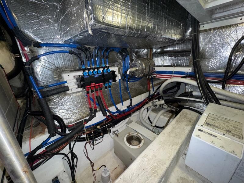 Engine room of a 2000 Carver 506 Motor Yacht with wiring and insulation.