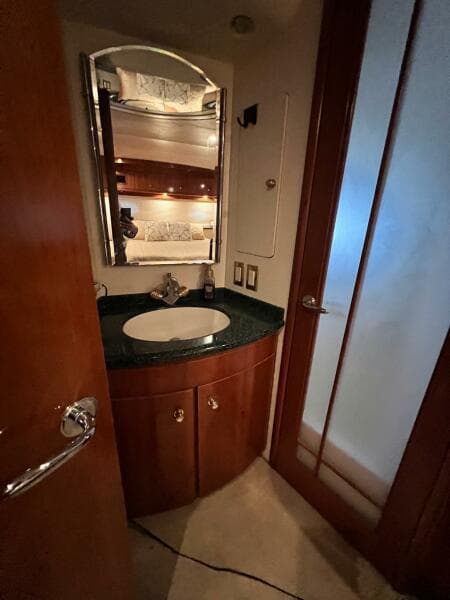 Bathroom interior of 2000 Carver 506 Motor Yacht with sink and mirror.