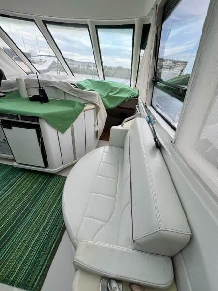 Interior of 2000 Carver 506 Motor Yacht with white seating and green accents.