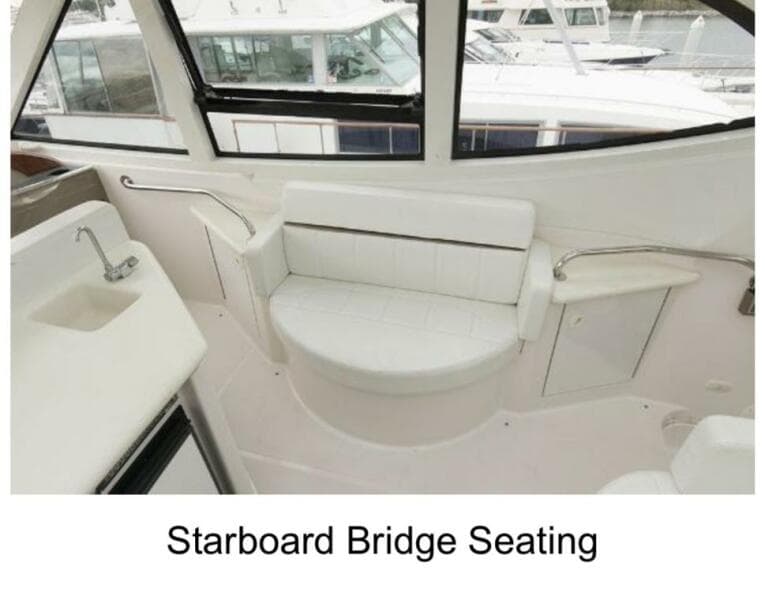Starboard bridge seating on 2000 Carver 506 Motor Yacht, featuring white cushioned bench.