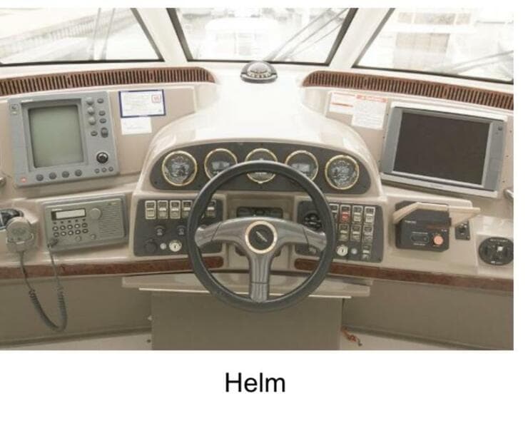 Helm of 2000 Carver 506 Motor Yacht with navigation instruments and steering wheel.