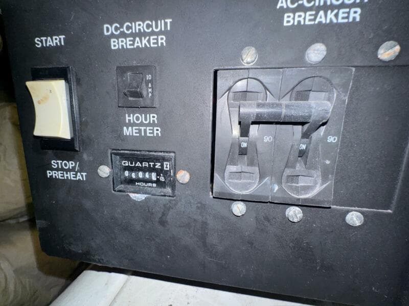 Control panel of a 2000 Carver 506 Motor Yacht with hour meter and circuit breakers.