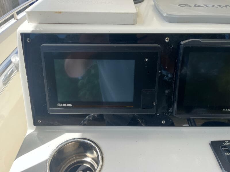 Control panel of a 1998 Blue Fin 25 Center Console boat with Yamaha and Garmin displays.