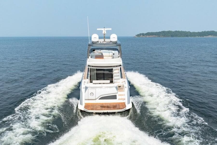 2023 Azimut Fly 53 yacht cruising on open water, rear view.