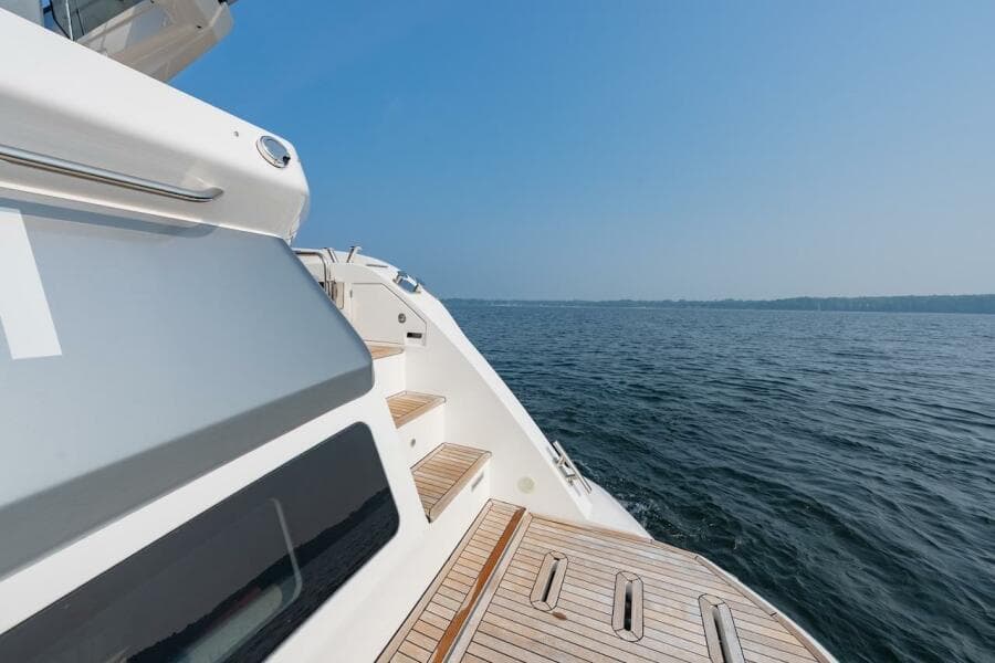 2023 Azimut Fly 53 yacht deck with ocean view under clear blue sky.