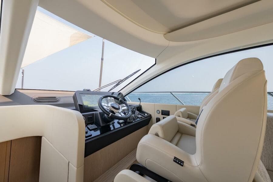 Luxurious interior of 2023 Azimut Fly 53 yacht with modern helm and leather seating.