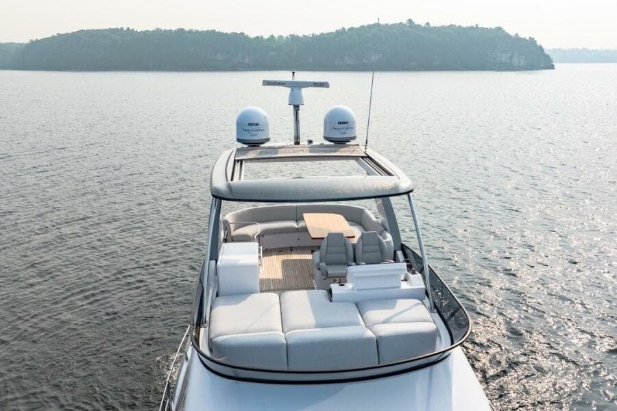 2023 Azimut Fly 53 yacht cruising on serene waters, showcasing luxurious deck seating.