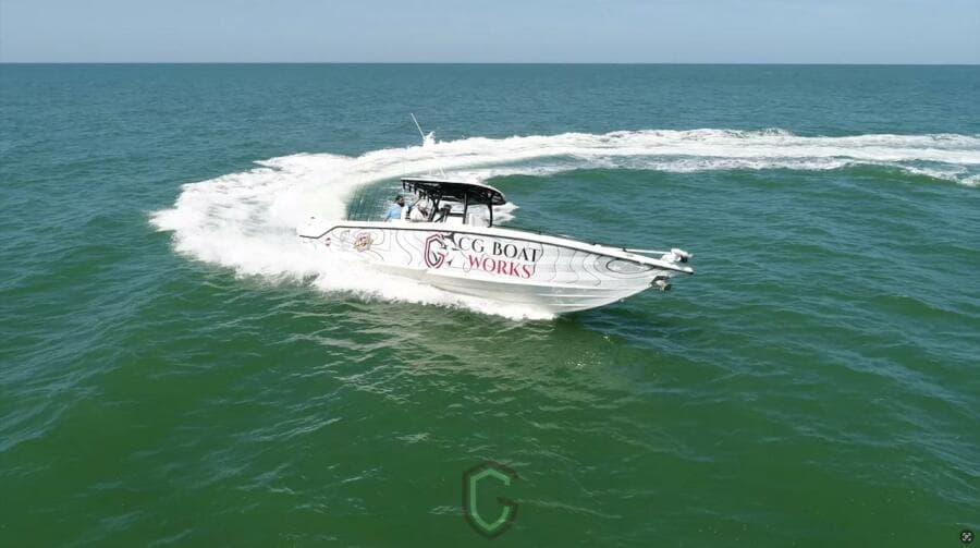 2023 CG Boat Works 35 M-Series cruising on open water, creating a dynamic wake.