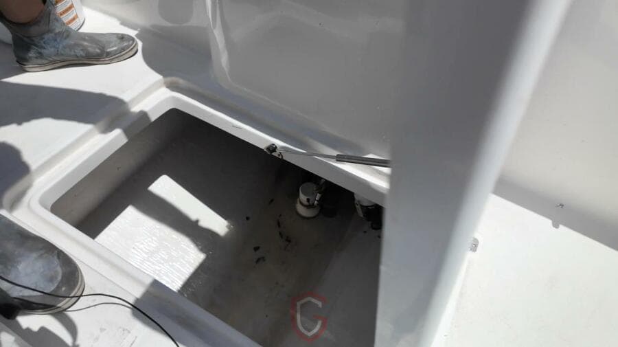 Open compartment on 2023 CG Boat Works 35 M-Series deck, showing interior details.