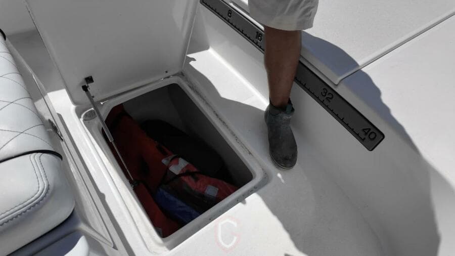 Open storage compartment on 2023 CG Boat Works 35 M-Series, featuring a measuring scale.