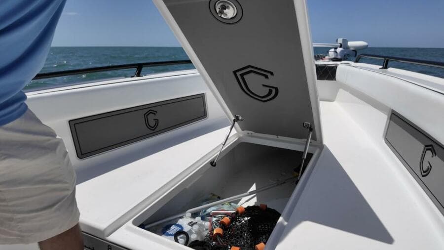 2023 CG Boat Works 35 M-Series open storage compartment on deck, ocean in background.