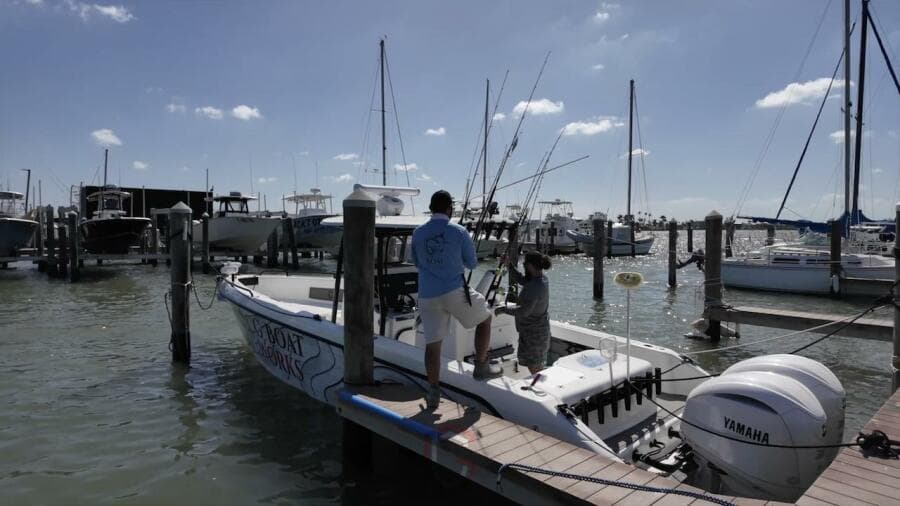2023 CG Boat Works 35 M-Series docked with people preparing fishing gear.