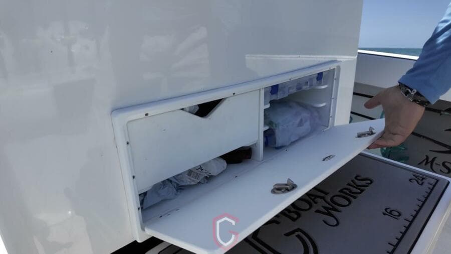 Storage compartment on 2023 CG Boat Works 35 M-Series, open with visible contents.