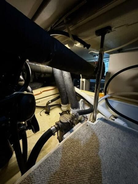 Engine room of a 2004 Carver 360 Sport Sedan with visible hoses and components.