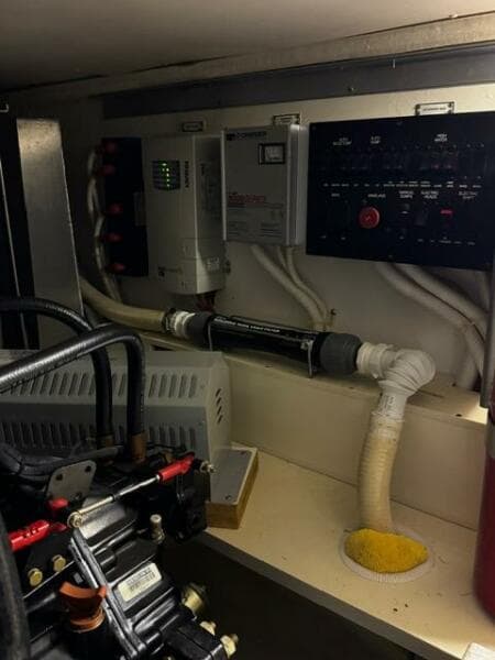 Engine room of a 2004 Carver 360 Sport Sedan with control panels and wiring.