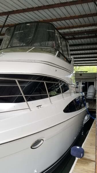 2004 Carver 360 Sport Sedan yacht docked in covered marina.