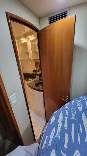 Interior view of 2004 Carver 360 Sport Sedan, showing a partially open door to a compact bathroom.