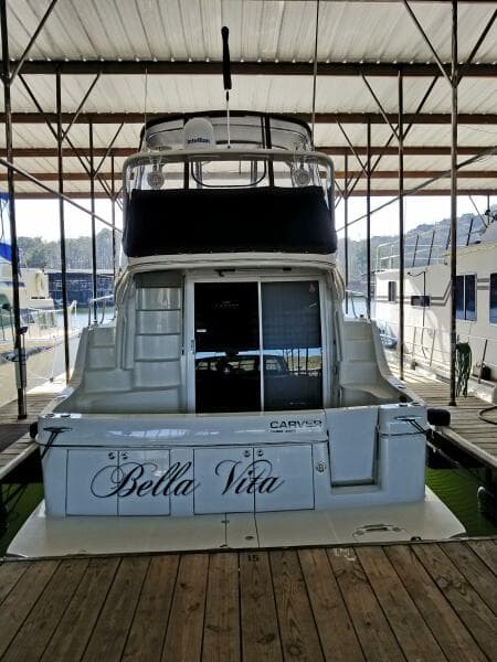 2004 Carver 360 Sport Sedan yacht named "Bella Vita" docked in a marina.