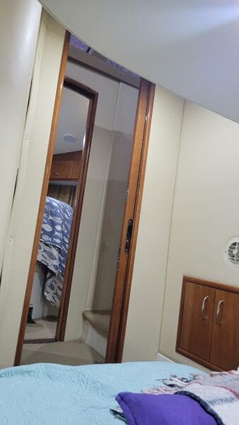 Interior of 2004 Carver 360 Sport Sedan with cozy bedroom and wooden cabinetry.