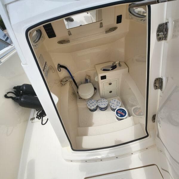 2021 Cobia 301 Center Console interior with storage and marine toilet.