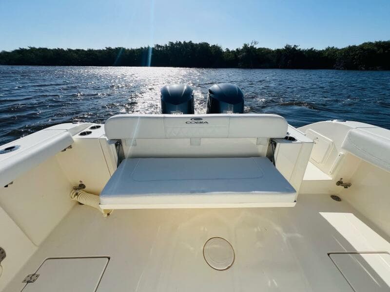 2021 Cobia 301 Center Console boat with dual engines on a sunny day.