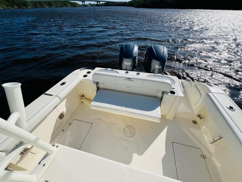 2021 Cobia 301 Center Console boat with dual engines on a sunny day.