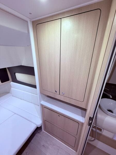 2024 Scout 400 LXF cabin interior with wood cabinetry and seating area.