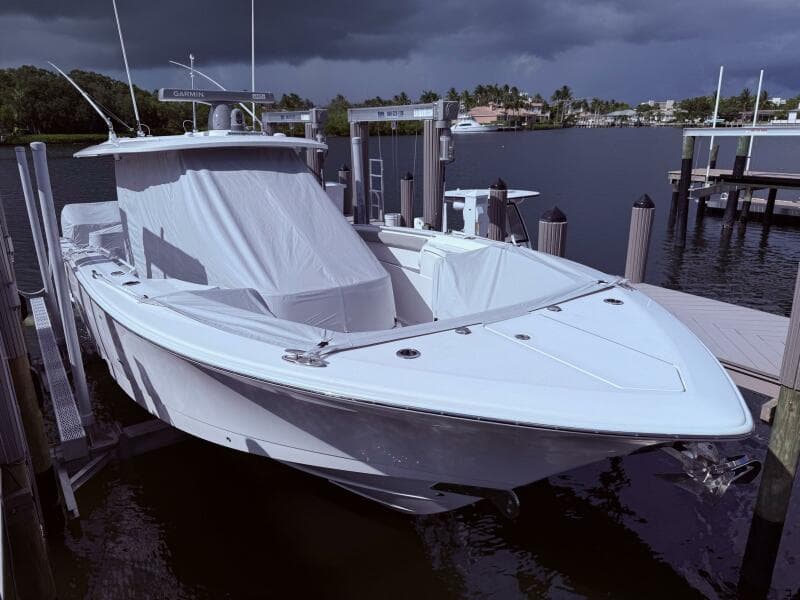 2024 Scout 400 LXF boat docked under cloudy skies.
