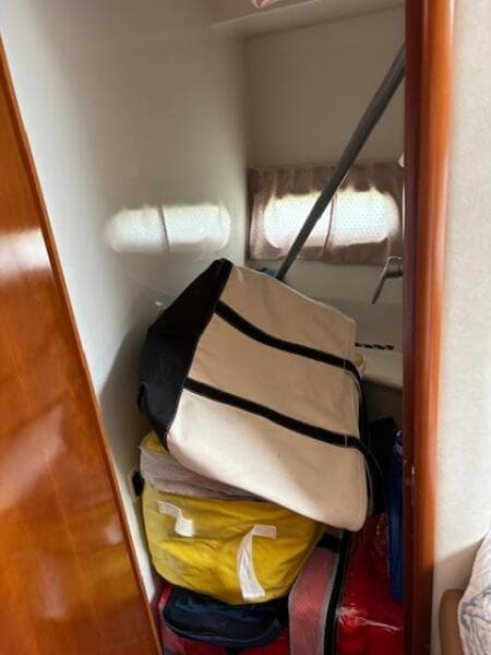Storage area inside 2006 Carver 43 Motor Yacht with bags and equipment.