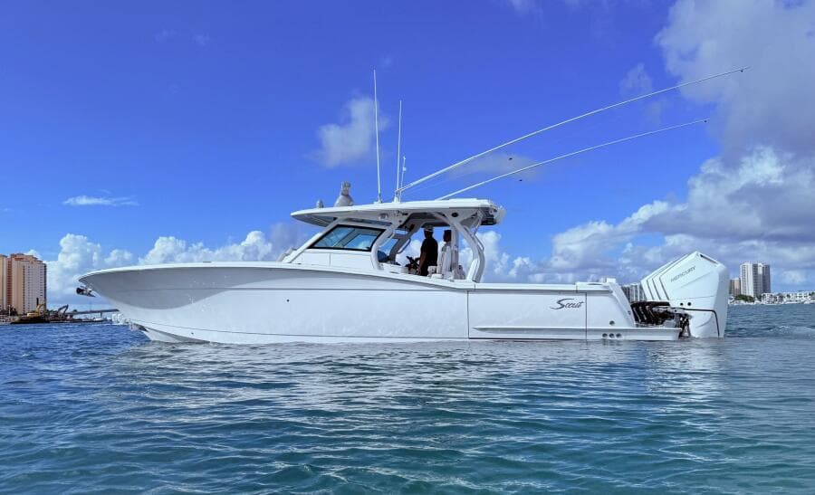 2024 Scout 400 LXF boat on water under clear blue sky.