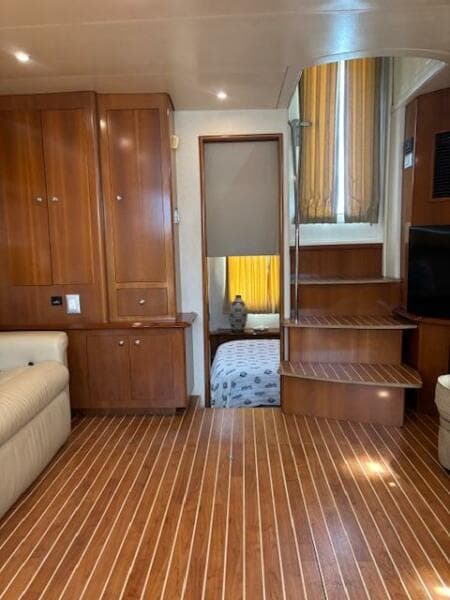 Interior of 2006 Carver 43 Motor Yacht with wooden flooring and cozy furnishings.