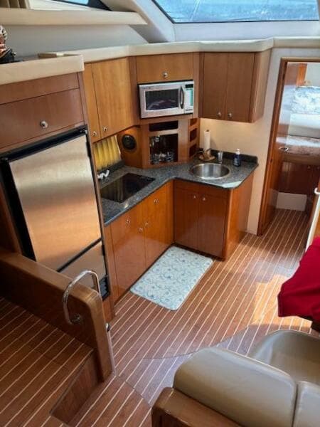 Interior of 2006 Carver 43 Motor Yacht with kitchen and wood flooring.