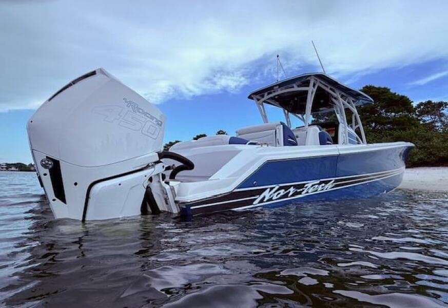 2022 Nor-Tech 390 Sport Center Console boat in water, showcasing sleek design and powerful engine.