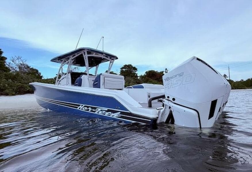 2022 Nor-Tech 390 Sport Center Console boat on water, featuring powerful outboard engines.