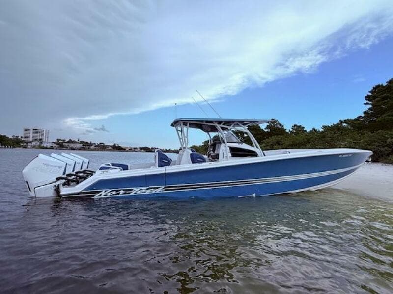 2022 Nor-Tech 390 Sport Center Console boat in shallow water, side view.
