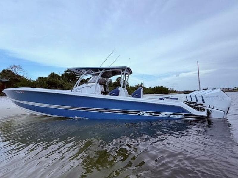2022 Nor-Tech 390 Sport Center Console boat in shallow water, side view.