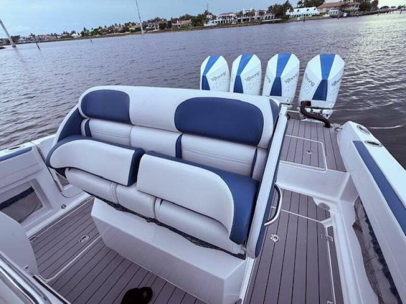 2022 Nor-Tech 390 Sport Center Console boat with blue and white seating and four engines.